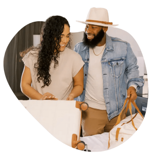 Couple Packing Bags in Hotel Room