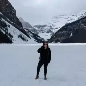 Carly Fielding, Marketing Assistant, standing on a frozen Lake Louise in Canada